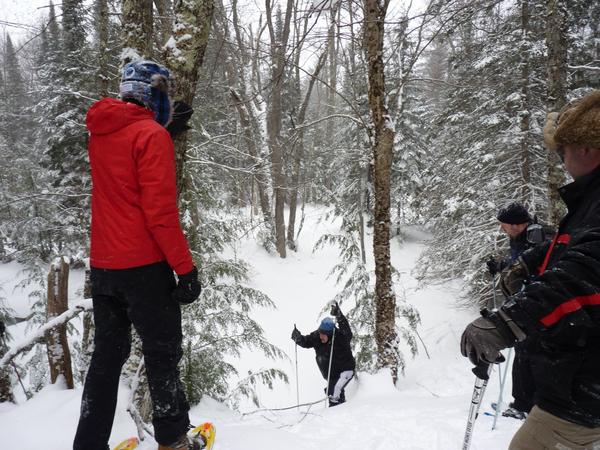 Watching Jon climb a hill on snowshoes.