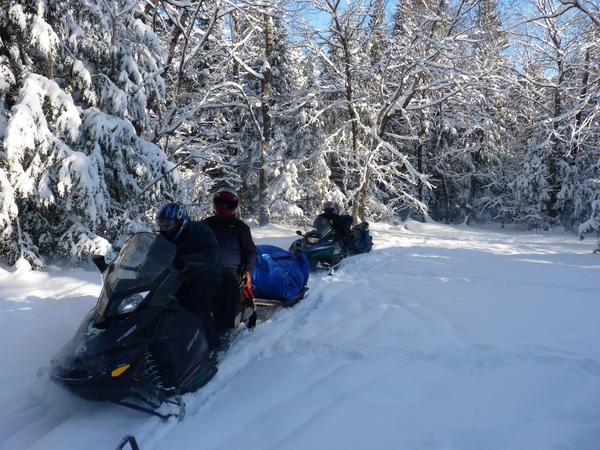 Snowmobiles loaded and heading out on the first trip.