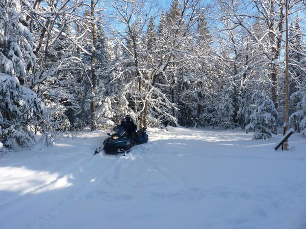 Snowmobiles loaded and heading out on the first trip.