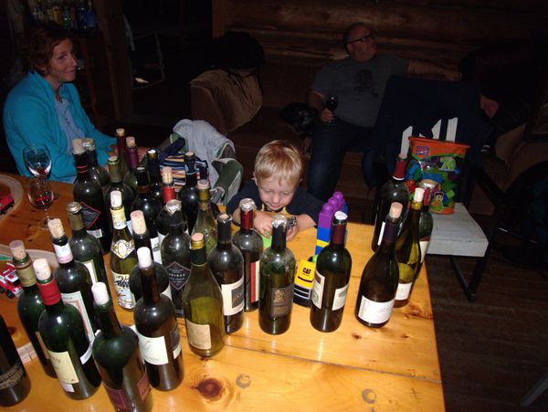 Frankie playing amidst the wine bottles being removed for recycling.