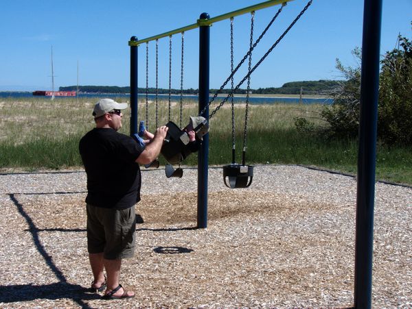 Jon swinging Teddy at the beach in Grand Marais.