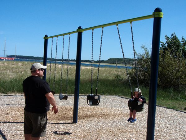 Jon swinging Teddy at the beach in Grand Marais.