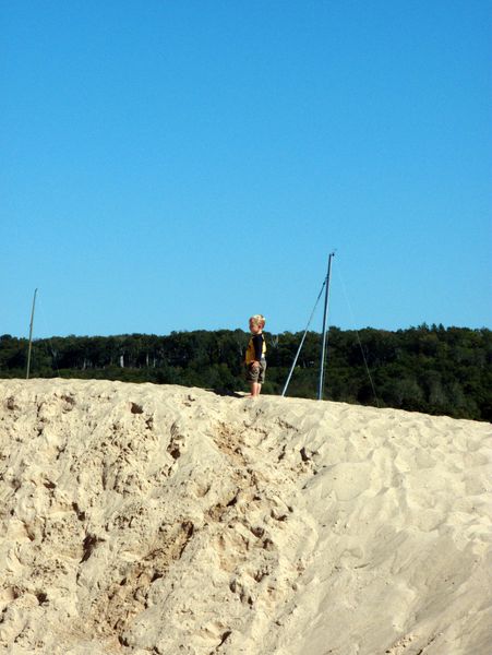 Frankie on top a the small dune at the beach in Grand Marais.