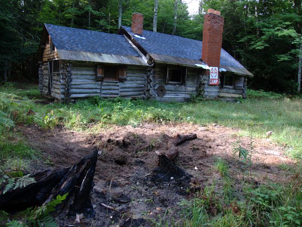 The Cabin with the remenants of the stump in the foreground.