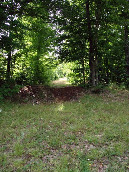 Dirt berm blocking one of the side roads.