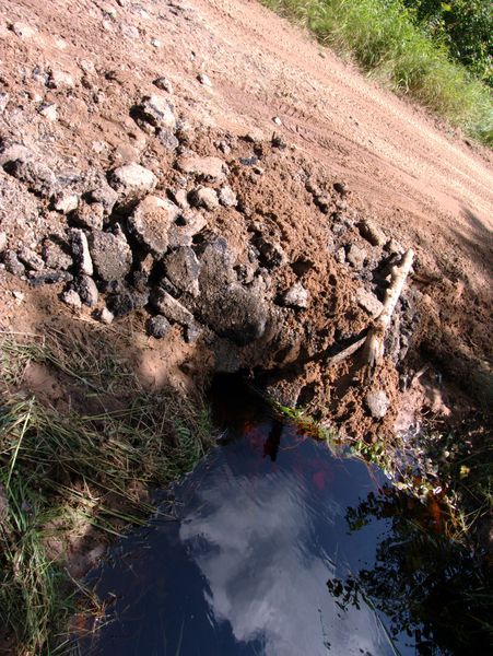 Patched washout on McCloud Grade. Here is the water
             flowing under the road.