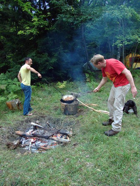 Jordan and Bill returning the paella pan to the fire.