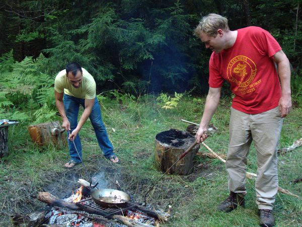 Jordan and Bill returning the paella pan to the fire.
