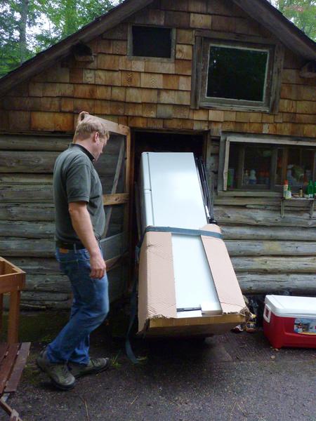 Bill and Mike moving in the new refrigerator.