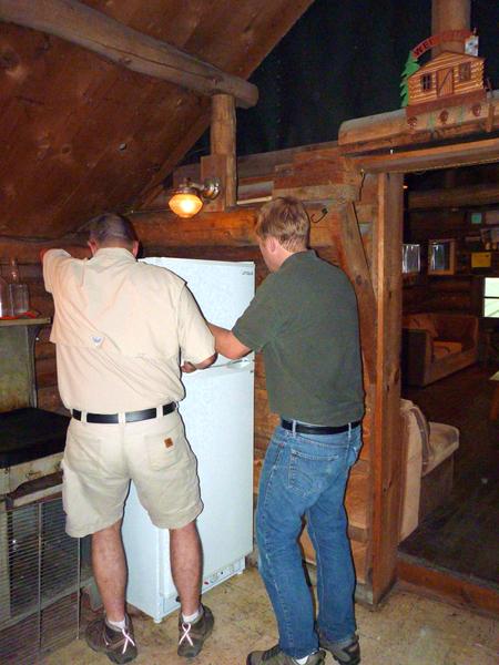 Bill and Mike moving in the new refrigerator.