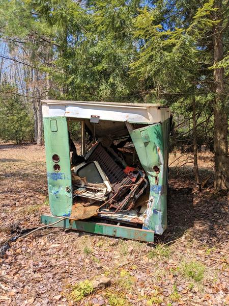 Old, upside down snowmobile in the smashed truck at a site along Newton Lake.