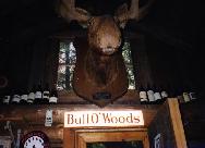 Wine bottles
	  stored near the moose head.